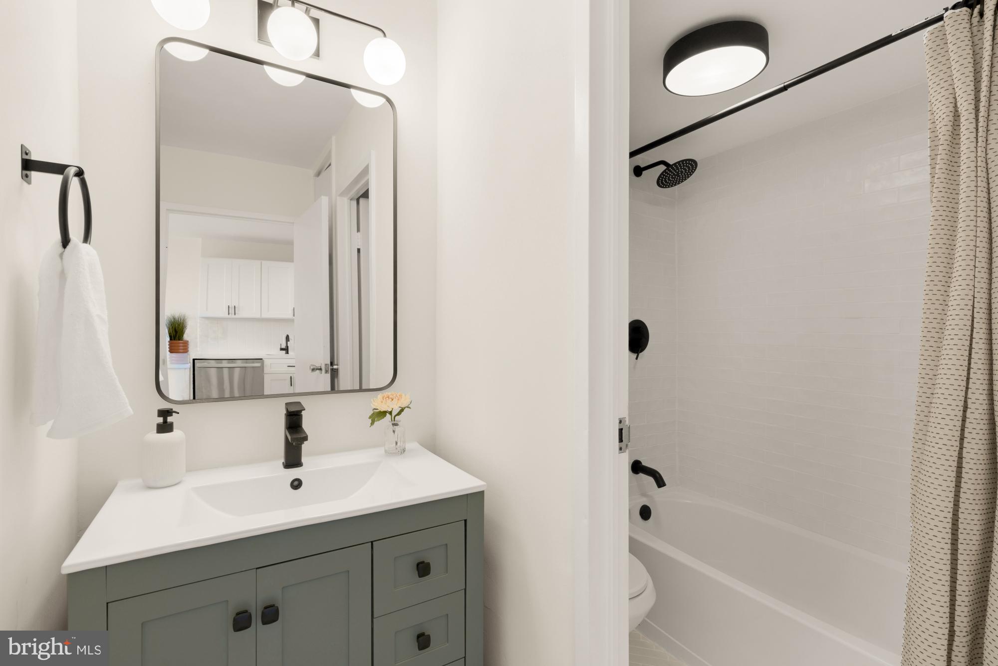 2800 Wisconsin Avenue Northwest, Unit 609 Washington, DC 20007 - Photo 19 of 20 a bathroom with a bathtub shower sink vanity and mirror