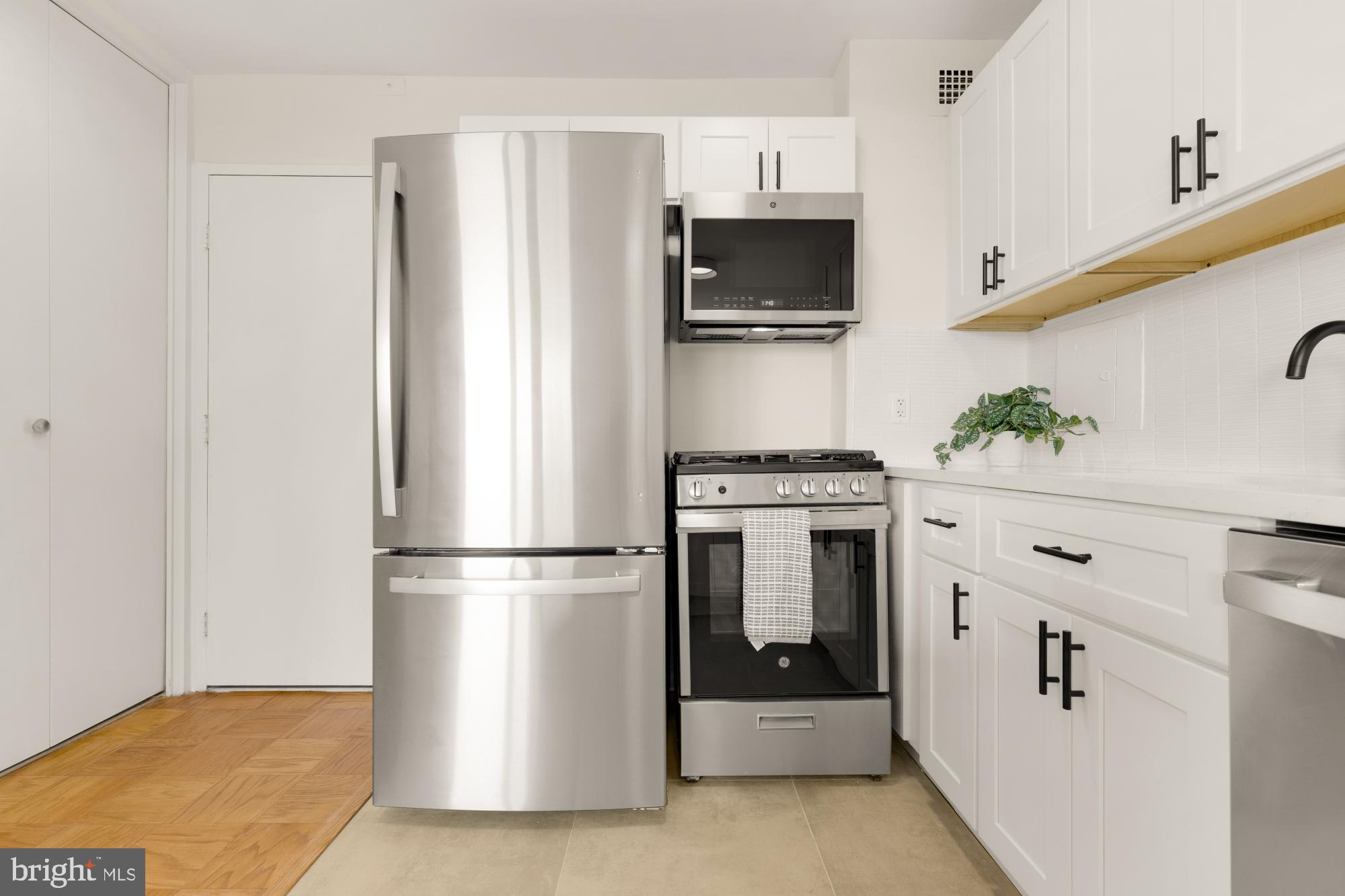 2800 Wisconsin Avenue Northwest, Unit 609 Washington, DC 20007 - Photo 8 of 20 a kitchen with white cabinets and stainless steel appliances