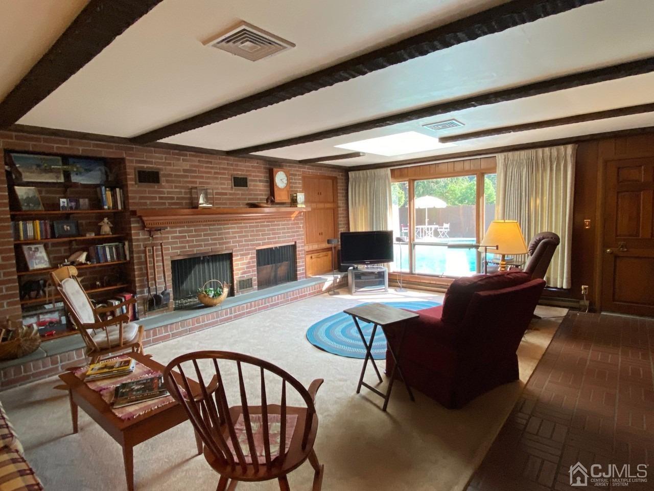 2 O Brien Road Cranbury, NJ 08512 - Photo 13 of 35 a living room with fireplace furniture and a floor to ceiling window