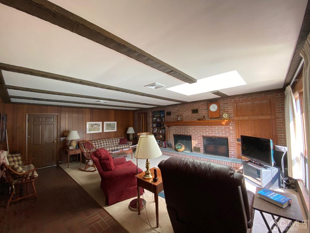 2 O Brien Road Cranbury, NJ 08512 - Photo 14 of 35 a living room with furniture a fireplace and a flat screen tv