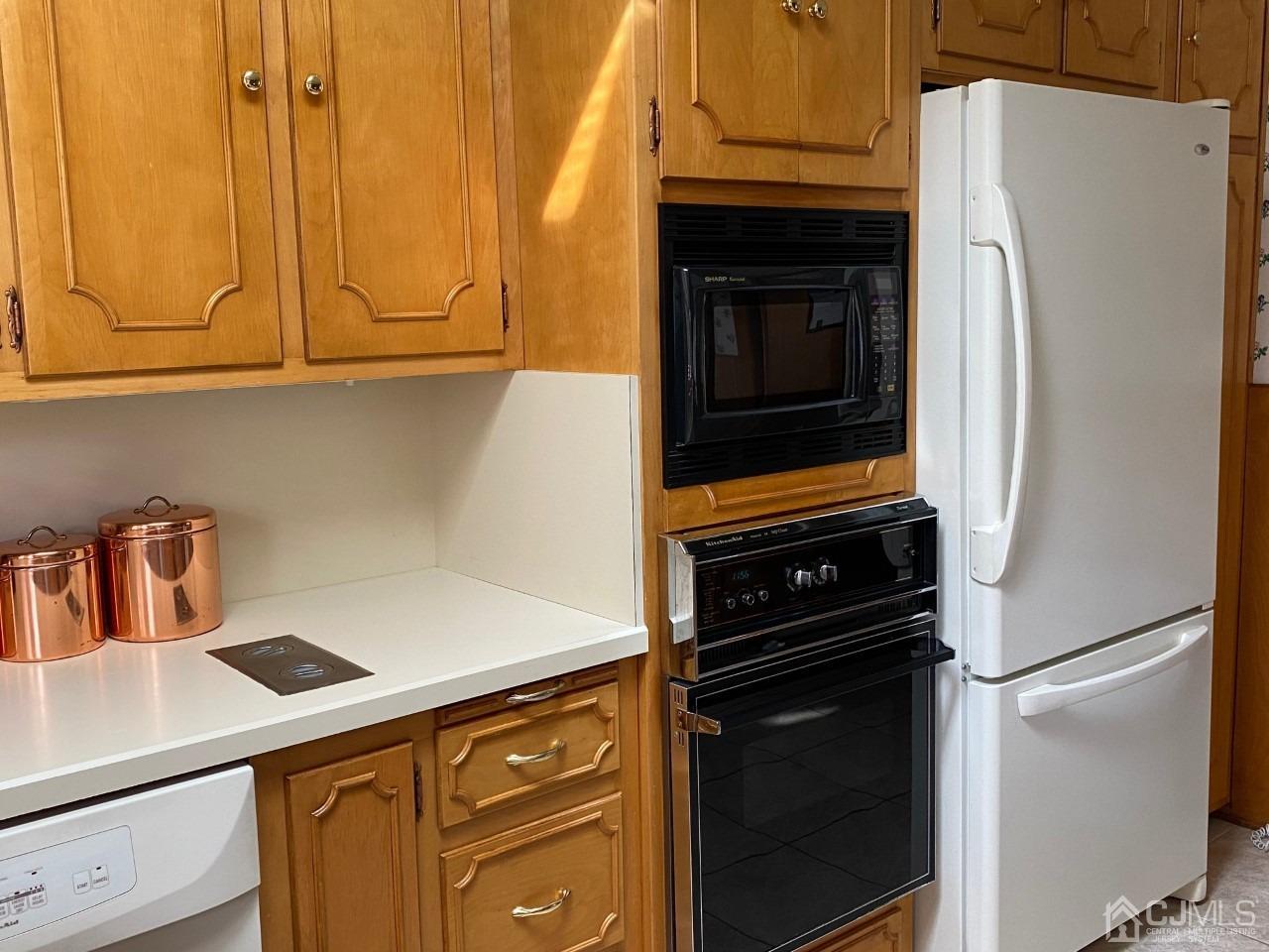 2 O Brien Road Cranbury, NJ 08512 - Photo 18 of 35 a kitchen with a refrigerator stove and cabinets