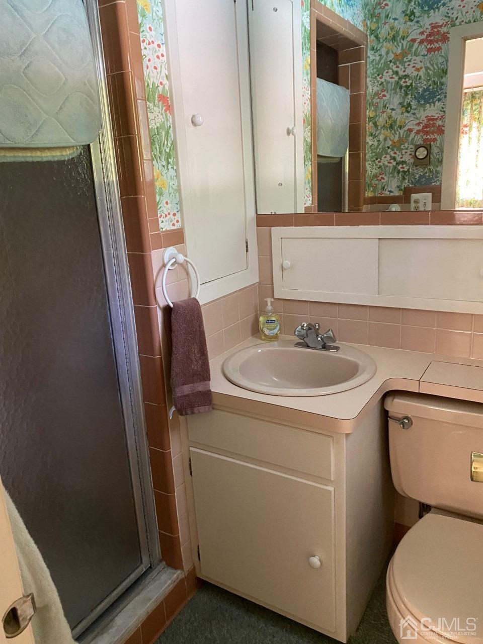 2 O Brien Road Cranbury, NJ 08512 - Photo 27 of 35 a bathroom with a sink a toilet and a mirror