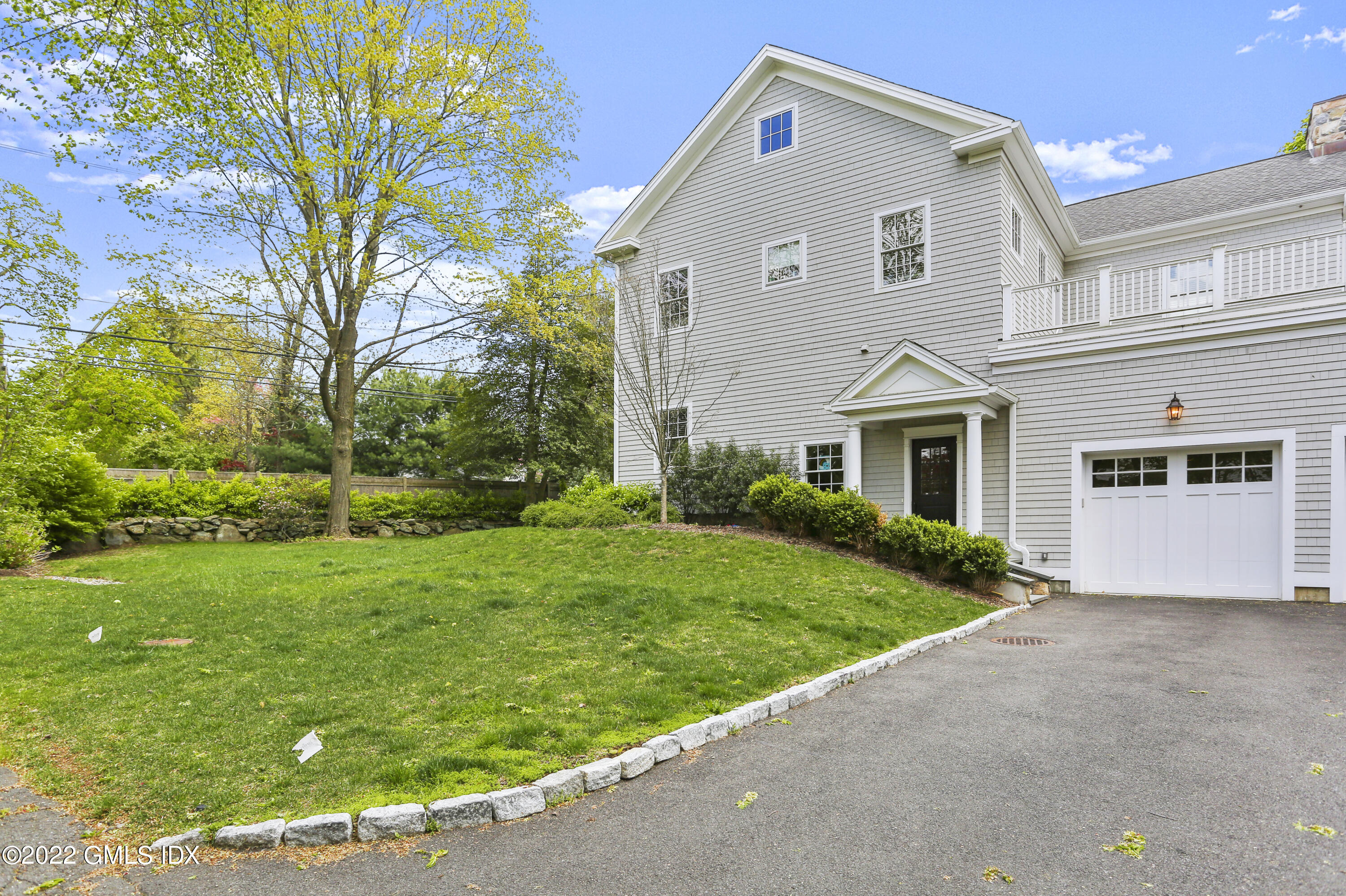 2 Pierce Road Riverside, CT 06878 - Photo 2 of 26 a front view of a house with a yard and garage