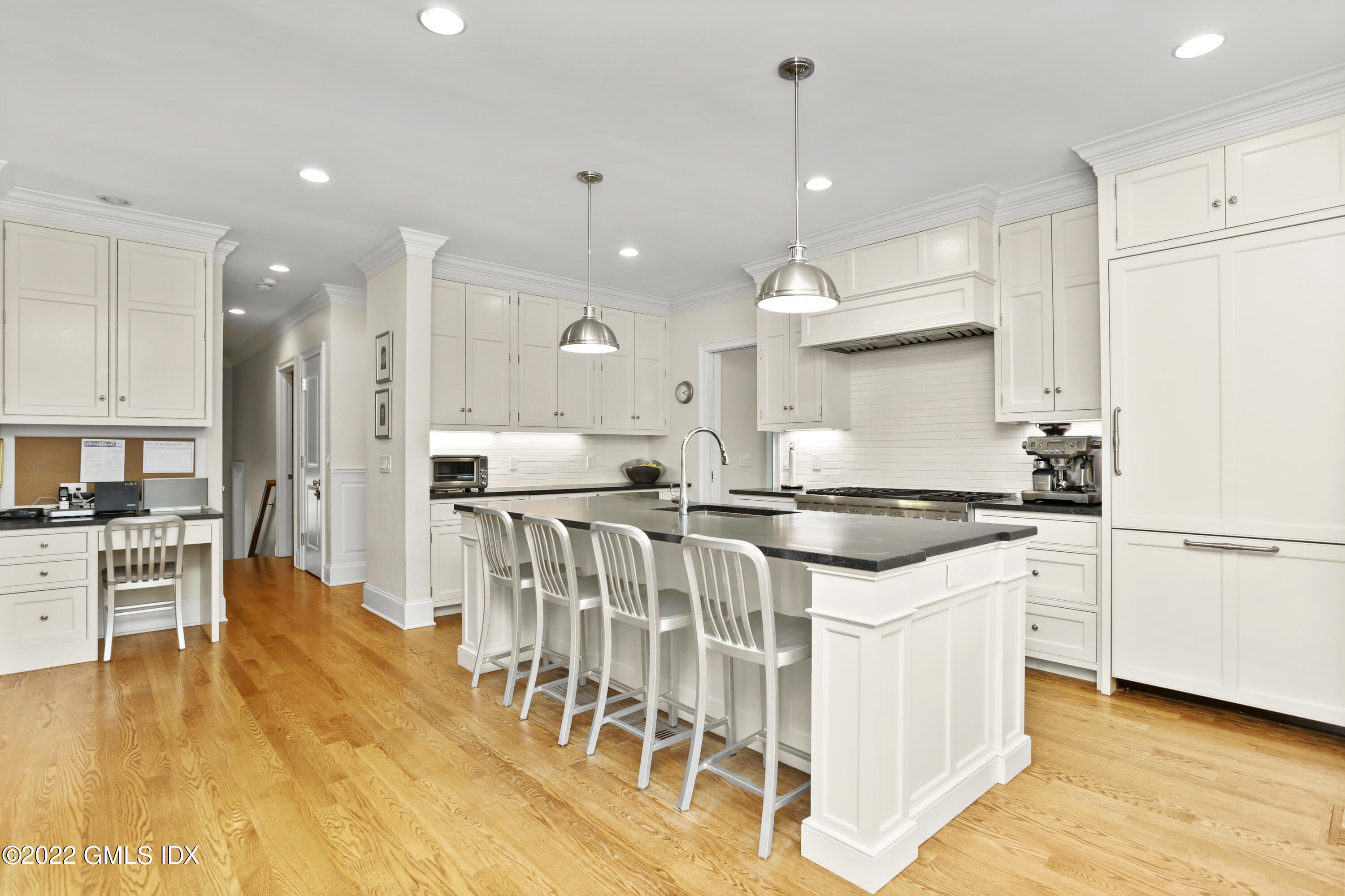 2 Pierce Road Riverside, CT 06878 - Photo 7 of 26 a kitchen with stainless steel appliances granite countertop a stove top oven a refrigerator a sink and white cabinets with wooden floor