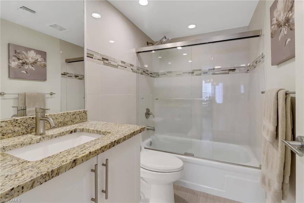 3055 Riviera Drive, Unit 201 Naples, FL 34103 - Photo 11 of 18 Guest bathroom featuring enclosed tub / shower combo, vanity, and recessed lighting