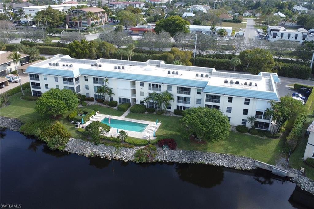 3055 Riviera Drive, Unit 201 Naples, FL 34103 - Photo 17 of 18 Drone / aerial view of Lake Suzanne and Camelot Club
