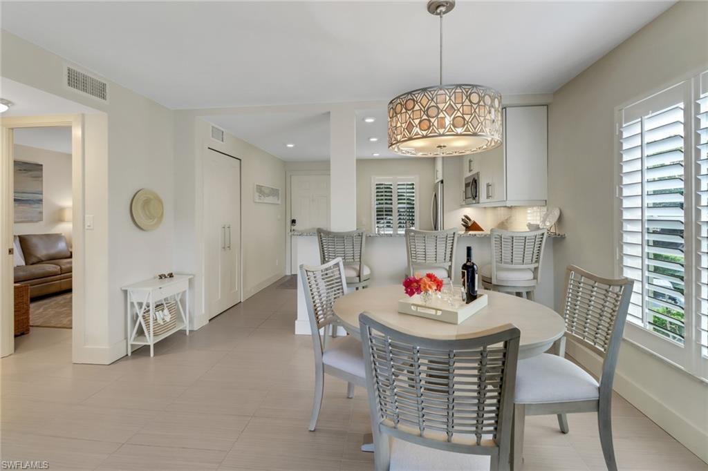 3055 Riviera Drive, Unit 201 Naples, FL 34103 - Photo 5 of 18 Dining area with recessed lighting and light tile patterned floors