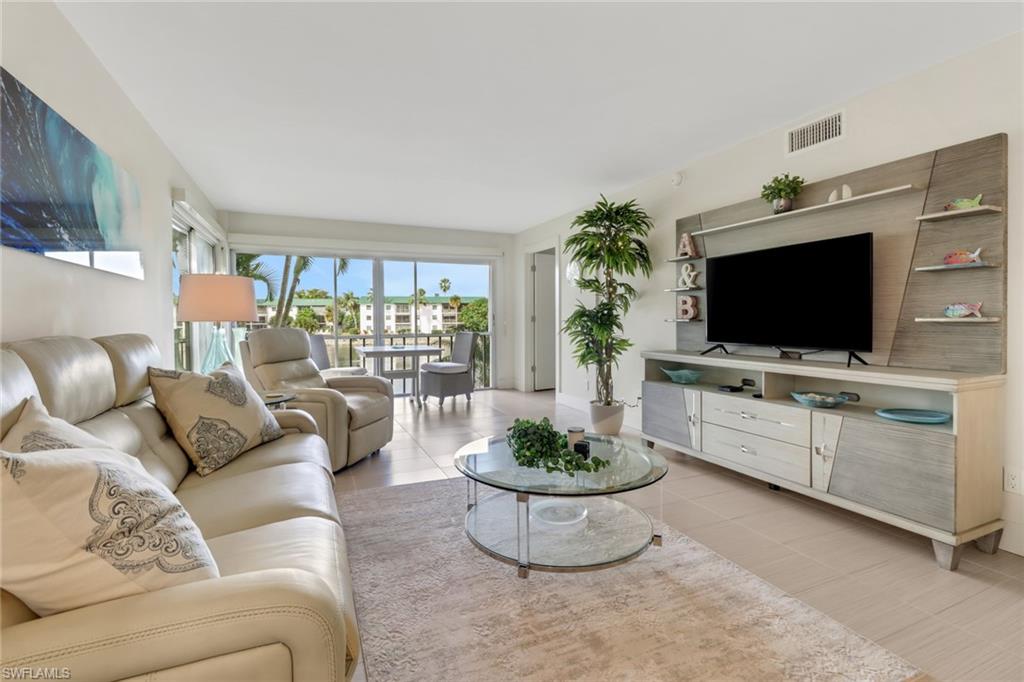 3055 Riviera Drive, Unit 201 Naples, FL 34103 - Photo 6 of 18 Living room featuring light tile patterned floors