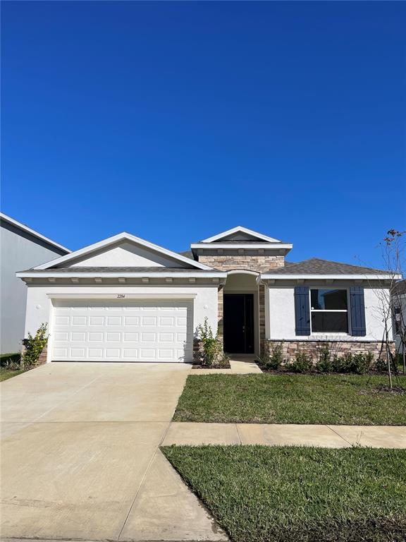 2284 Rikkola Lane Wesley Chapel, FL 33543 - Photo 2 of 3 a front view of a house with a yard