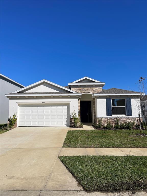 2284 Rikkola Lane Wesley Chapel, FL 33543 - Photo 3 of 3 a front view of a house with garden