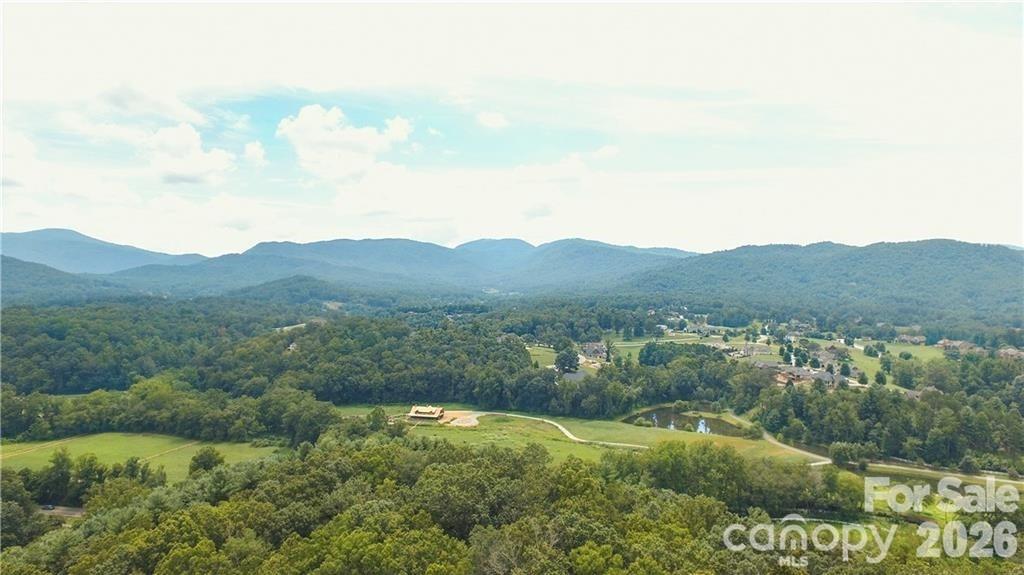19 Laurel Loop Road Fletcher, NC 28732 - Photo 13 of 13 a view of a grassy area with mountains and a houses