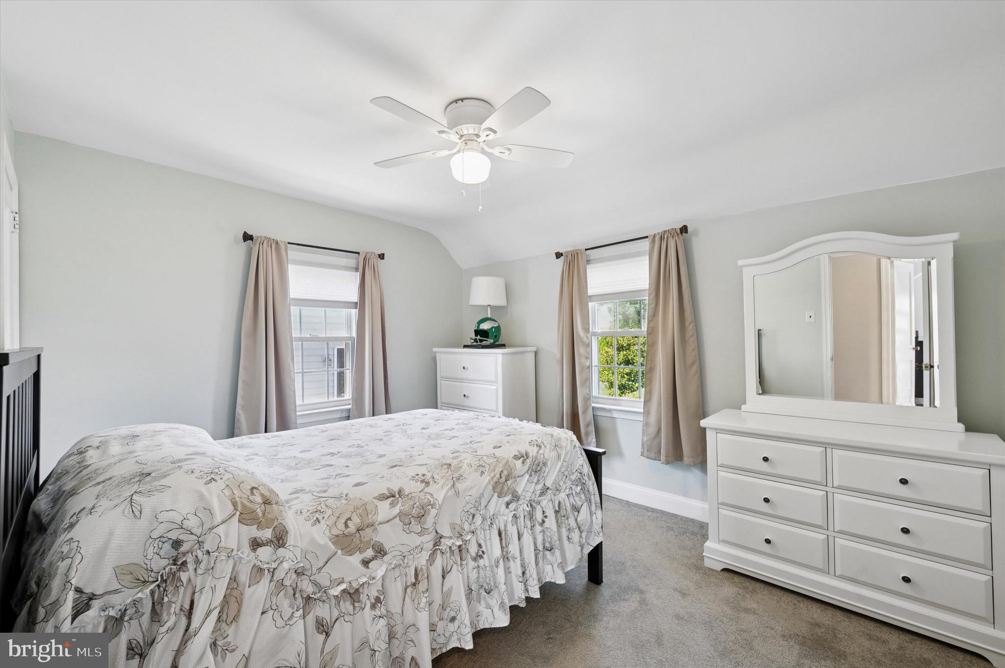 313 Edgemore Road Secane, PA 19018 - Photo 15 of 22 a spacious bedroom with a large bed and a chandelier