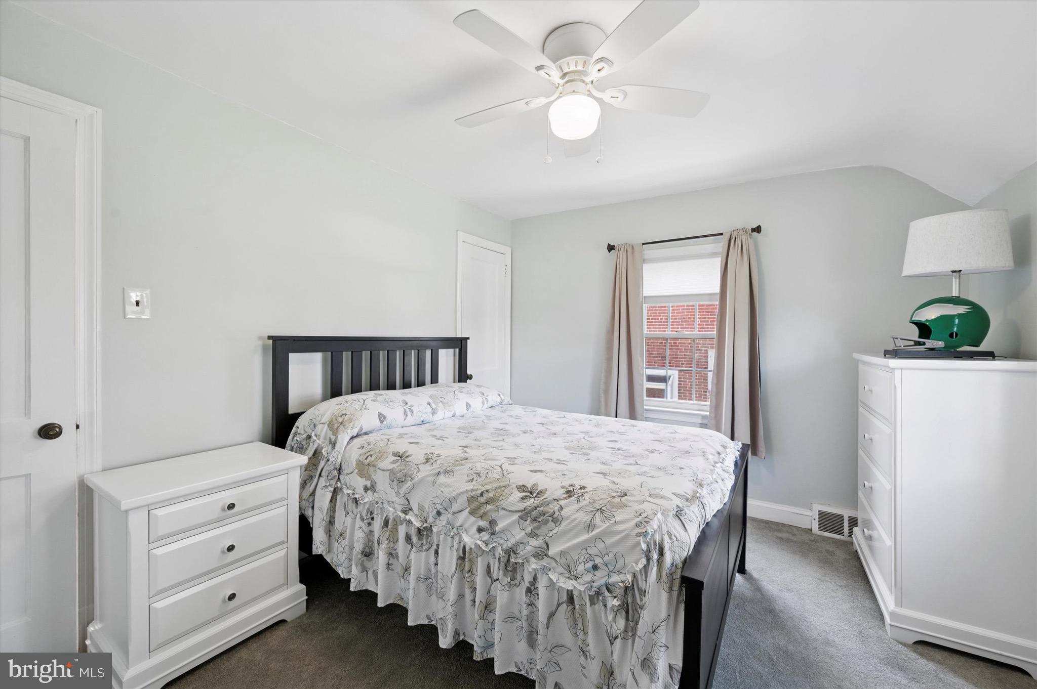 313 Edgemore Road Secane, PA 19018 - Photo 16 of 22 a bedroom with a bed and a chandelier