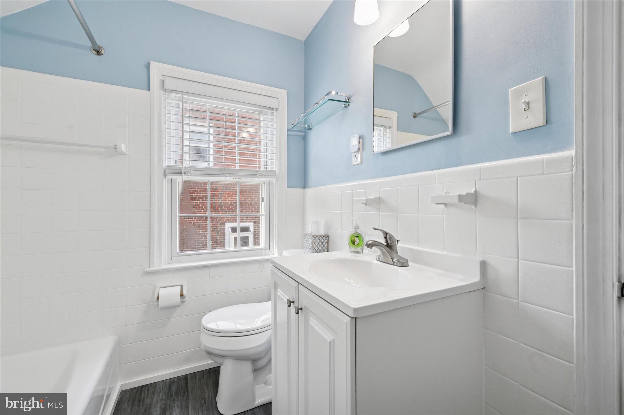 313 Edgemore Road Secane, PA 19018 - Photo 17 of 22 a bathroom with a sink a toilet and a window