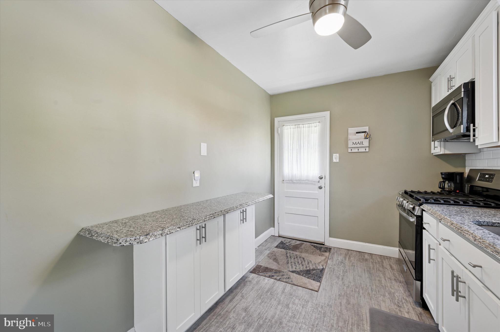 313 Edgemore Road Secane, PA 19018 - Photo 8 of 22 a kitchen with stainless steel appliances granite countertop a refrigerator and a stove top oven