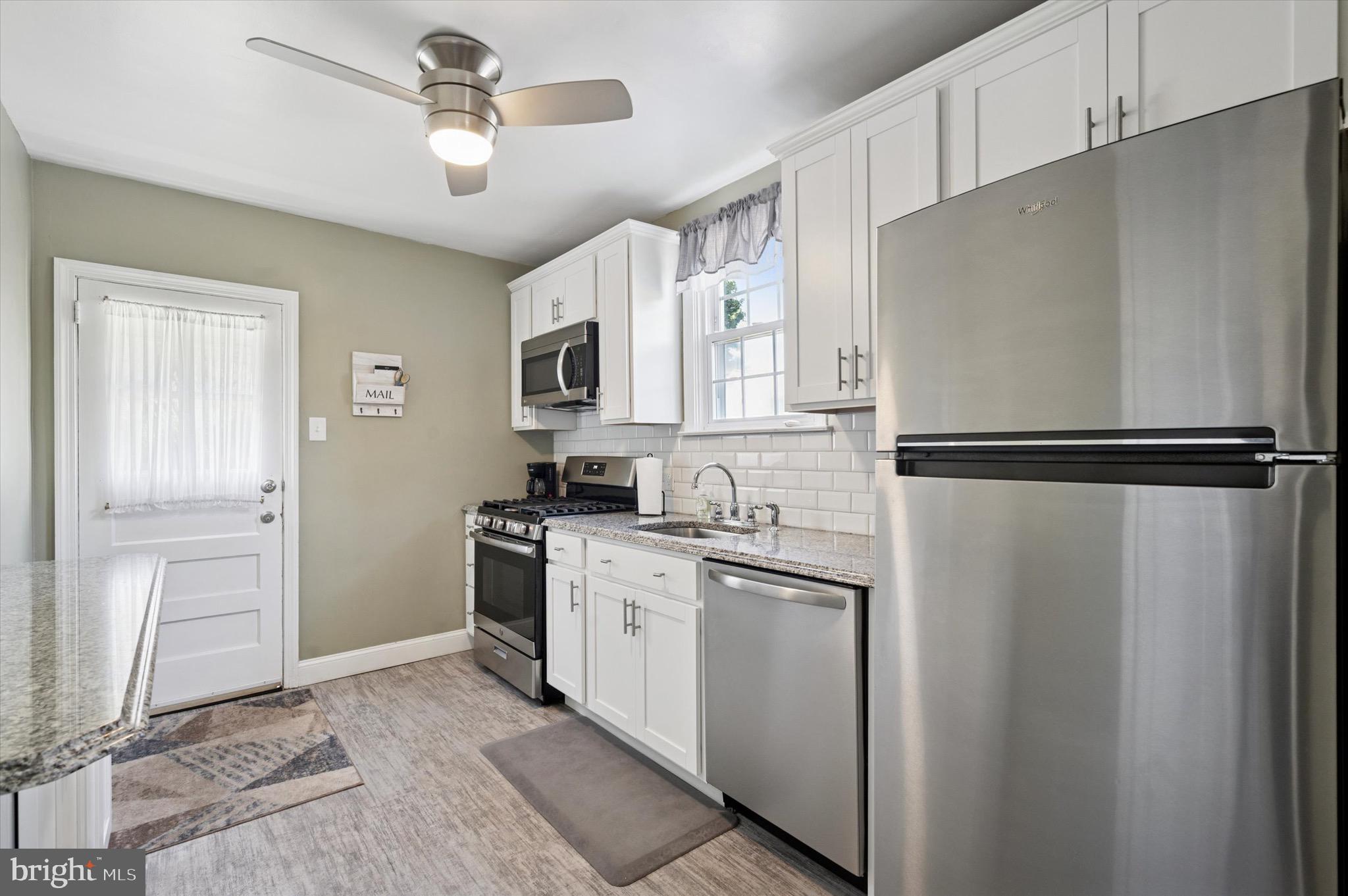 313 Edgemore Road Secane, PA 19018 - Photo 9 of 22 a kitchen with stainless steel appliances granite countertop a refrigerator a stove a sink and dishwasher