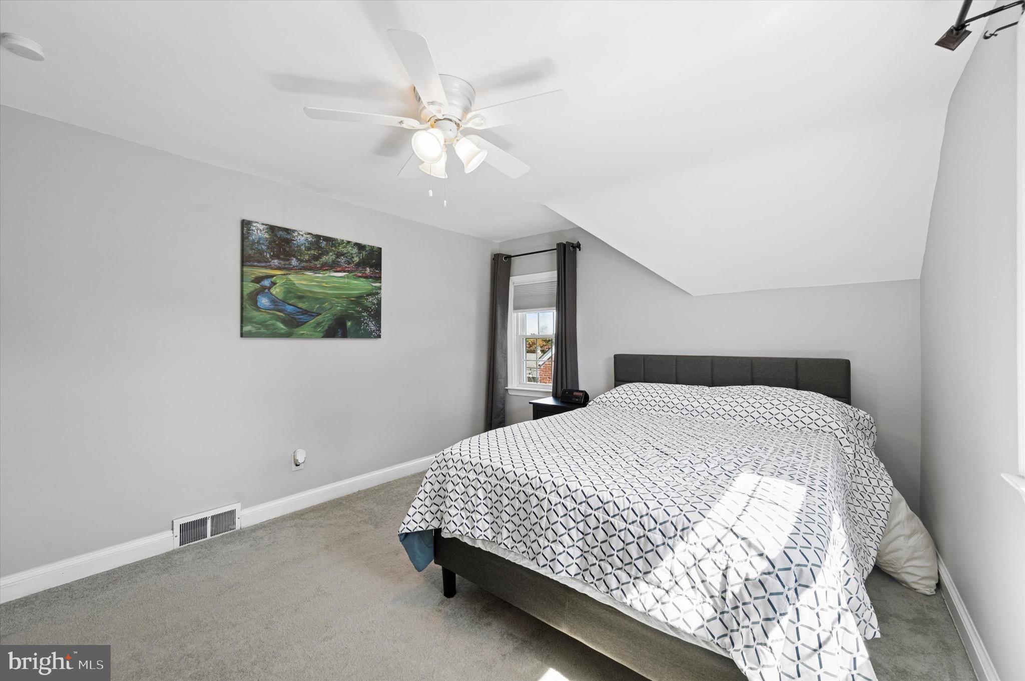 313 Edgemore Road Secane, PA 19018 - Photo 10 of 22 a bedroom with a bed and a chandelier