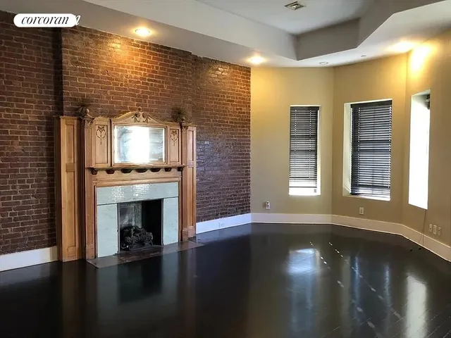 a kitchen with a wooden floor and a fireplace