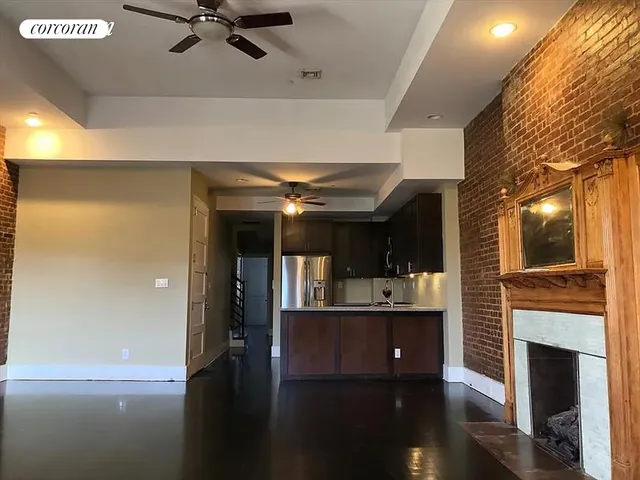 a living room with fireplace furniture and a wooden floor
