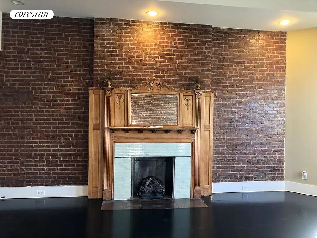 764 St Nicholas Avenue, Unit PH Manhattan, NY 10031 - Photo 5 of 14 a living room with a fireplace