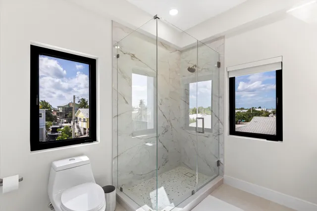 a bedroom with a large bed and a large window