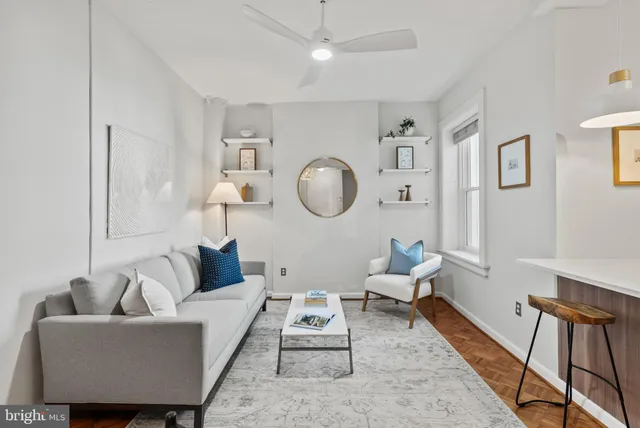 a living room with furniture a rug and a window