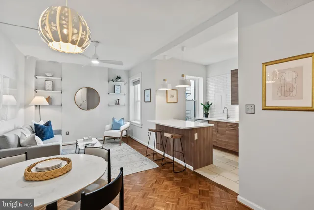 a living room with furniture a mirror and a table