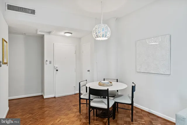 a view of a dining room with a table and chairs