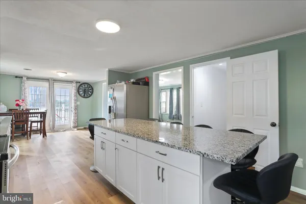 a living room with granite countertop furniture and a wooden floor