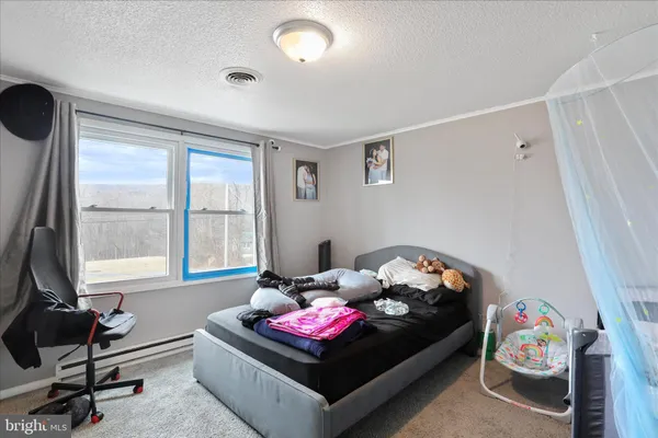 a bedroom with furniture and a window