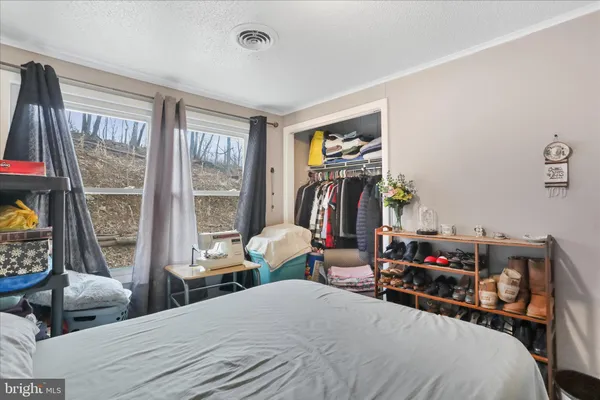 a bedroom with furniture and a large window