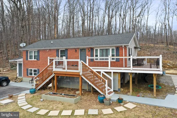 a view of house with roof deck and seating space