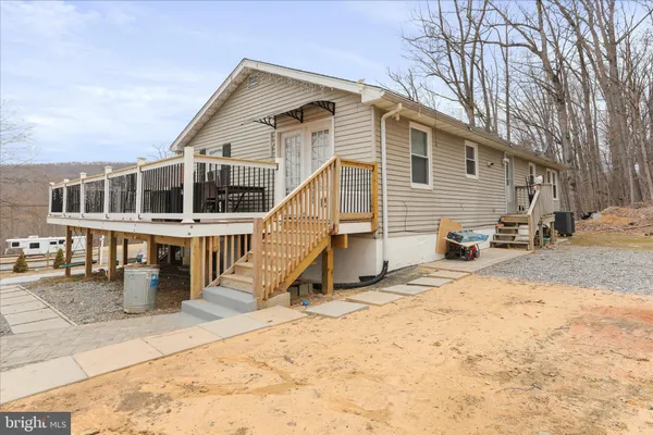 a view of a yard with wooden fence