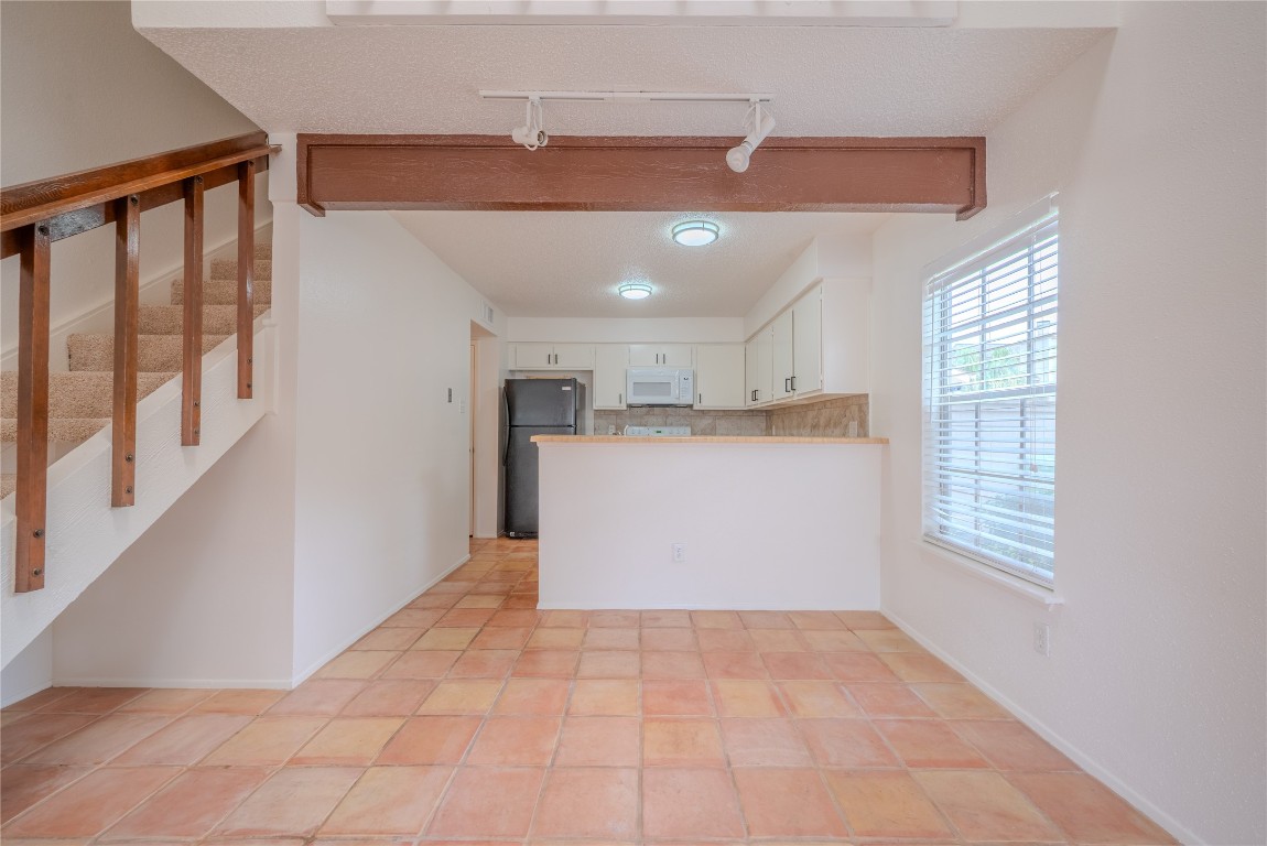 13034 Leader Street, Unit 960 Houston, TX 77072 - Photo 15 of 28 a view of a kitchen with a dishwasher and white cabinets