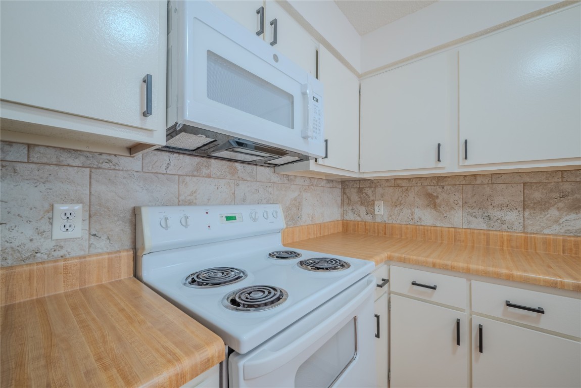13034 Leader Street, Unit 960 Houston, TX 77072 - Photo 17 of 28 a kitchen with a stove and a white cabinets