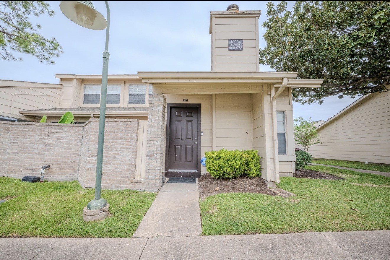 13034 Leader Street, Unit 960 Houston, TX 77072 - Photo 2 of 28 a front view of a house with a yard