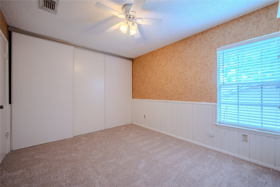 13034 Leader Street, Unit 960 Houston, TX 77072 - Photo 21 of 28 an empty room with windows and fan