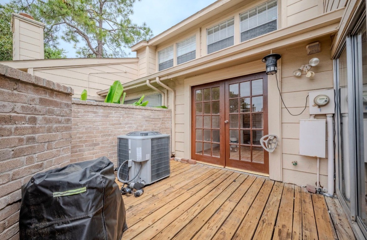 13034 Leader Street, Unit 960 Houston, TX 77072 - Photo 26 of 28 a view of a deck with wooden floor and a fireplace