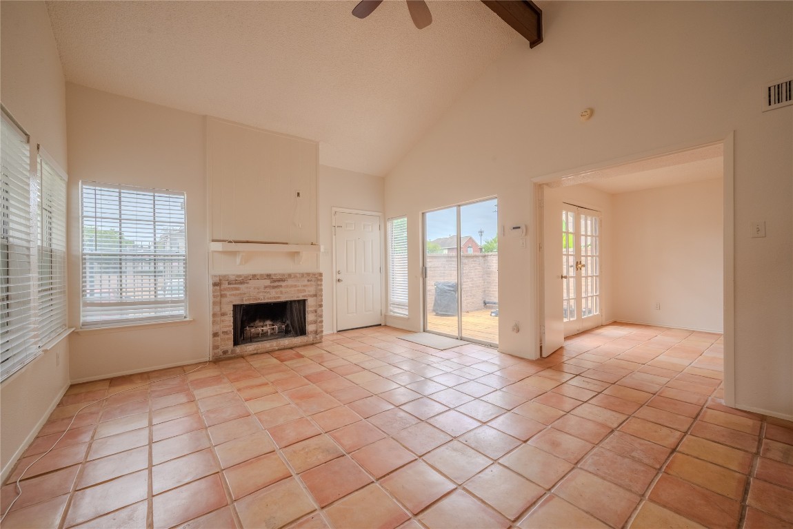 13034 Leader Street, Unit 960 Houston, TX 77072 - Photo 6 of 28 a view of an empty room with a fireplace and a window
