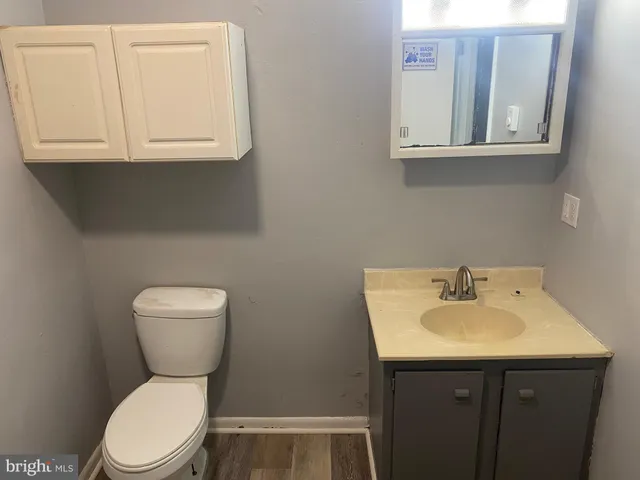 a bathroom with a toilet sink and mirror