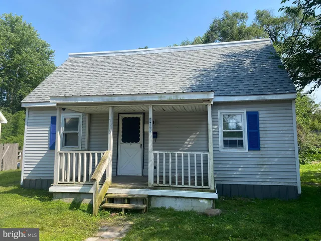 a view of a house with a yard and wooden fence