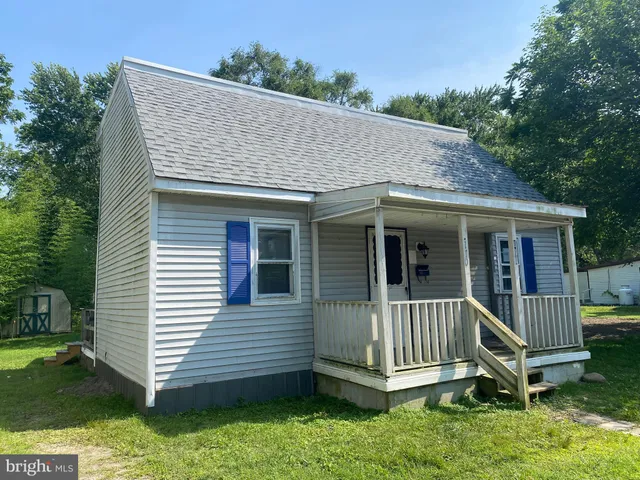 a view of a house with a yard and deck