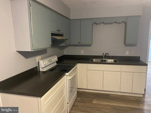 a kitchen with a sink and cabinets