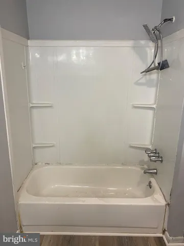 a bathroom with a shower and a bath tub