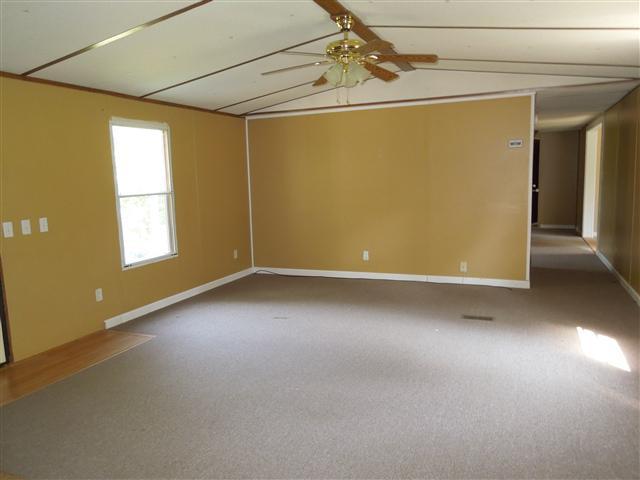 681 Edenway Road Dover, TN 37058 - Photo 11 of 20 Living room, vaulted ceiling, ceiling fan, carpet.
