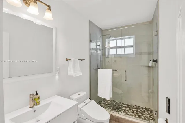 a bathroom with a sink toilet and shower