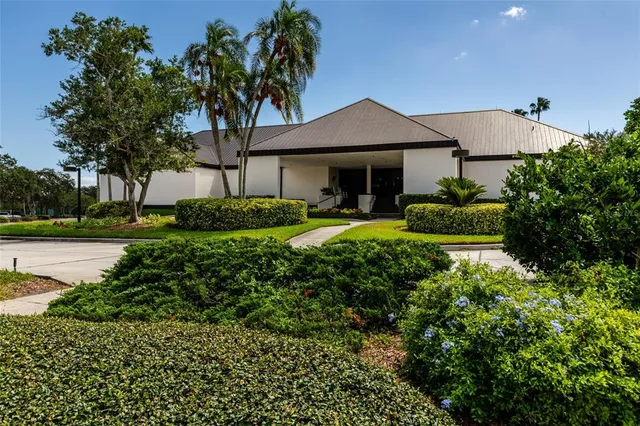 a spacious bedroom with a bed and large windows