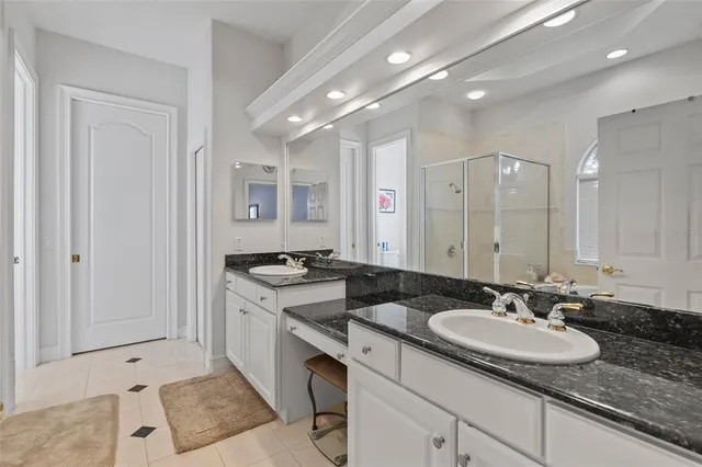 a kitchen with granite countertop a sink a stove top oven and cabinets