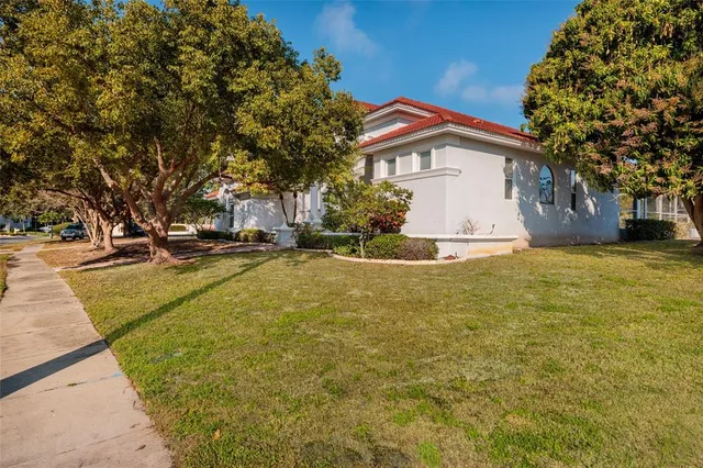 a yellow house with trees in front of it