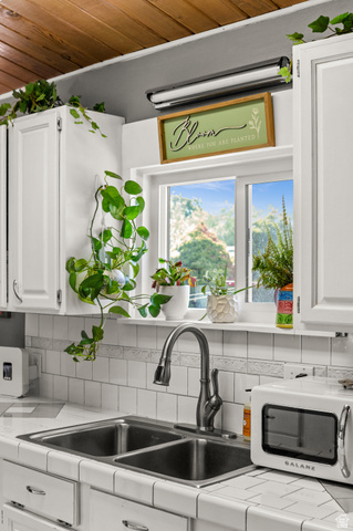 909 Rancho Boulevard Ogden, UT 84404 - Photo 20 of 27 Dual basin stainless steel sink with a high-arc faucet, set within white tiled countertops